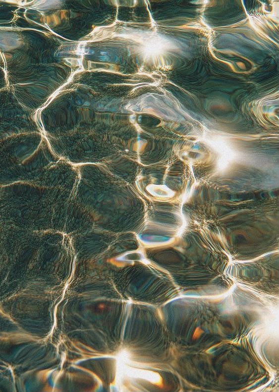Sunlight rippling across dark water
